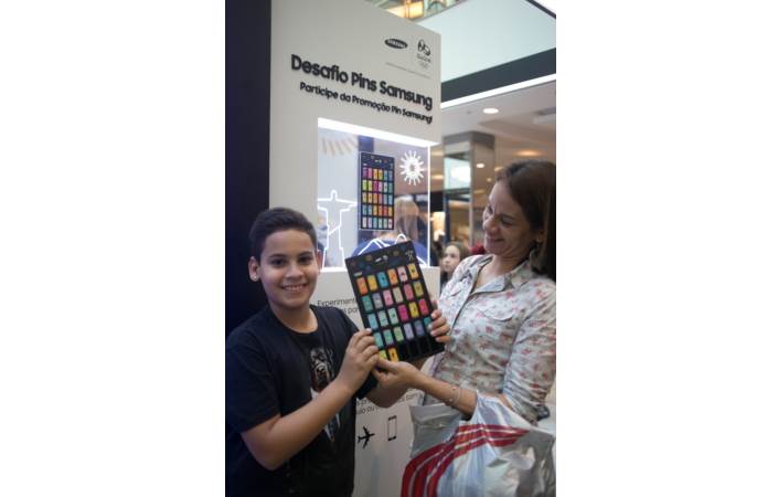 A young Olympic Games fan is all smiles as he shows off his nearly-completed pin board at the Samsung Galaxy Studio in Olympic Park. One lucky fan who collects all 30 pins and the pin board will win a round-trip package for two to Tokyo, Host City of the Tokyo 2020 Olympic Games. Additional prizes include the Samsung Galaxy S7 edge Olympic Games Limited Edition, Gear IconX cord-free fitness earbuds, and other mobile accessories.