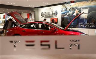 A man looks around Tesla Motors' Model S P85 at its showroom in Beijing A man looks around Tesla Motors' Model S P85 at its showroom in Beijing