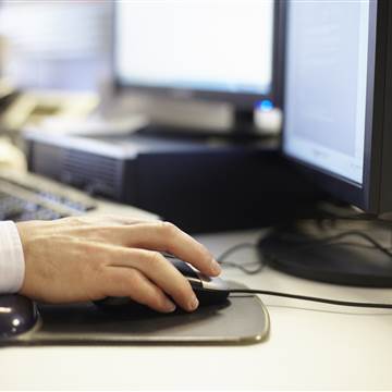 Image: A Man using computer in the office