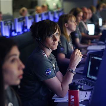 Image: Staff members watch on before the solar-powered Juno spacecraft went into orbit around Jupiter
