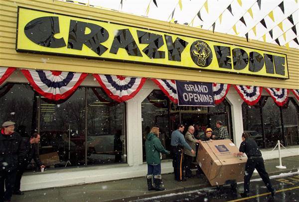 Image: Workers bring out a large-screen television at the grand opening of a new Crazy Eddie electronics store Image: Workers bring out a large-screen television at the grand opening of a new Crazy Eddie electronics store