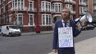Image: A comedian reads the Internet to Julian Assange outside Ecuador's embassy in London Image: A comedian reads the Internet to Julian Assange outside Ecuador's embassy in London