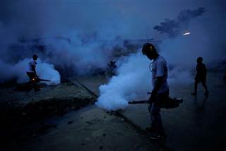 Image: Workers of the Ministry of Public Health and Population fumigate in the street against mosquito breeding to prevent diseases such as malaria, dengue and Zika, during a fumigation campaign in Port-au-Prince, Haiti Image: Workers of the Ministry of Public Health and Population fumigate in the street against mosquito breeding to prevent diseases such as malaria, dengue and Zika, during a fumigation campaign in Port-au-Prince, Haiti