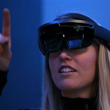 Image: A Microsoft employee demonstrates the Microsoft HoloLens augmented reality (AR) viewer