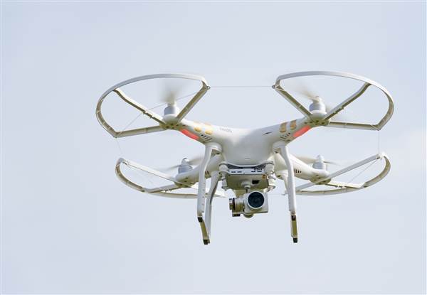 Image: White drone flying Image: White drone flying