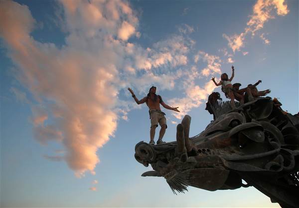 Image: Participants dance and climb on an art installation as approximately 70,000 people from all over the world gather for the 30th annual Burning Man arts and music festival in the Black Rock Desert of Nevada, U.S. Image: Participants dance and climb on an art installation as approximately 70,000 people from all over the world gather for the 30th annual Burning Man arts and music festival in the Black Rock Desert of Nevada, U.S.