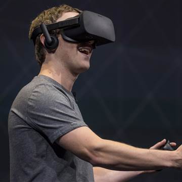 Image: Facebook founder and CEO,Mark Zuckerberg, demonstrates an Oculus Rift virtual reality (VR) headset and Oculus Touch controllers as the gives a demonstration during the Oculus Connect 3 event in San Jose, Calif., on Oct. 6, 2016.
