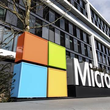 Image: The Microsoft logo on the facade of a Microsoft Center.
