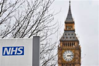 Image: A NHS sign is displayed outside a hospital in central London Image: A NHS sign is displayed outside a hospital in central London